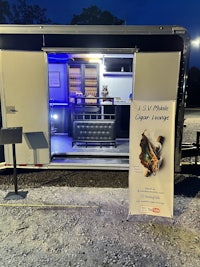 a food truck is parked in a parking lot at night