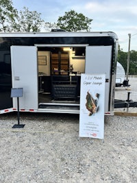 a black and white trailer with a sign on it